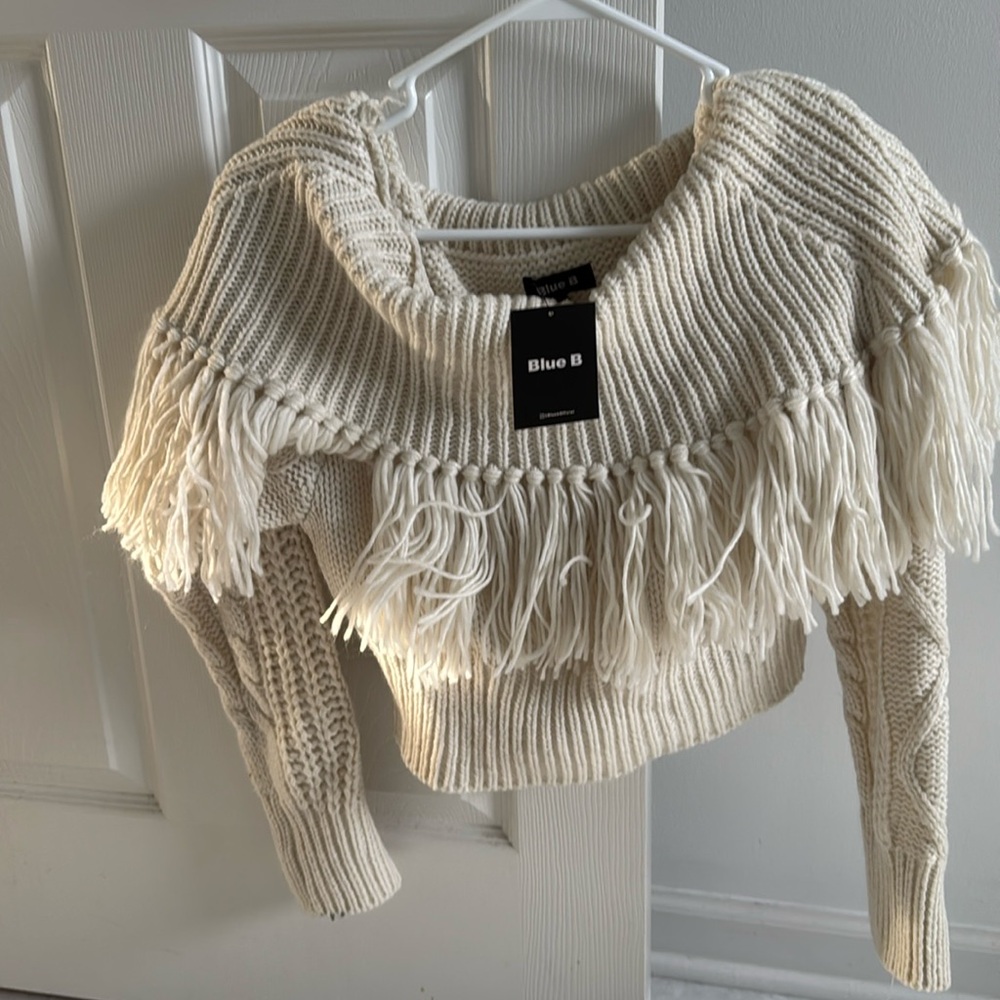 Cream colored never worn Blue B sweater new with tags size M/L.